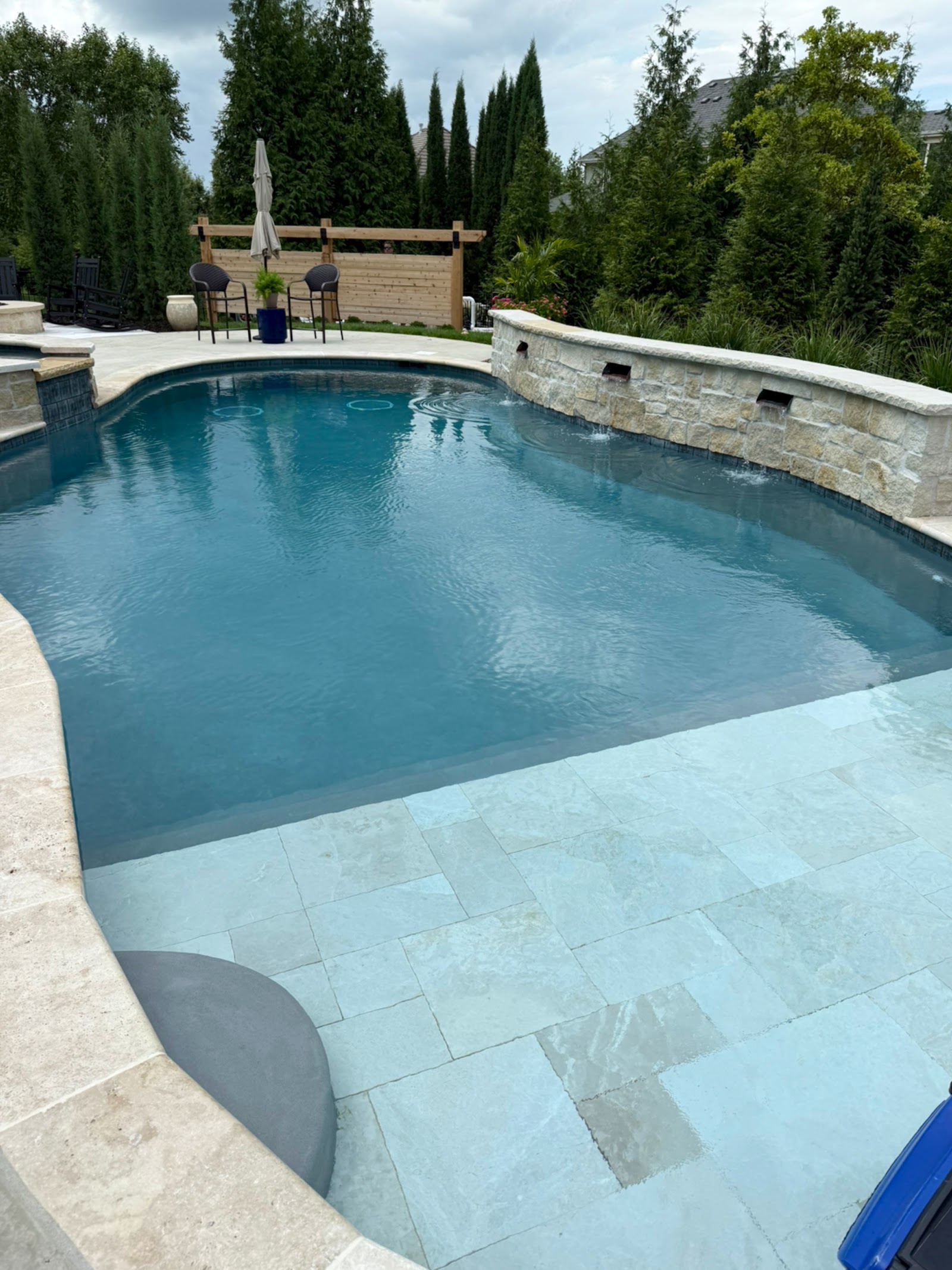 Custom free-form inground pool with stone water feature